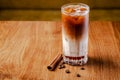 Iced coffee with ice. Frappe, frappuccino with cream and cinnamon on wooden table. copy space