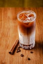 Iced coffee with ice. Frappe, frappuccino with cream and cinnamon on wooden table. copy space