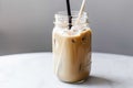 iced coffee latte in a jar, with straw and label for easy take-away