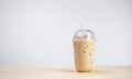 Iced coffee or coffee latte in takeaway cup on wooden table. coffee package for takeaway. Royalty Free Stock Photo