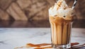 Iced coffee latte with whipped cream, topped with caramel sauce, in a tall glass Royalty Free Stock Photo