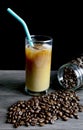 Iced coffee with milk and coffee beand on the table.