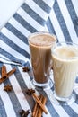 Iced coffee with milk in tall glasses, Cups of tasty frappe coffee, Latte machiato, two cups of cappuccino with cinnamon sticks Royalty Free Stock Photo