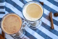 Iced coffee with milk in tall glasses, Cups of tasty frappe coffee, Latte machiato, two cups of cappuccino with cinnamon sticks Royalty Free Stock Photo