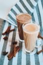 Iced coffee with milk in tall glasses, Cups of tasty frappe coffee, Latte machiato, two cups of cappuccino with cinnamon sticks