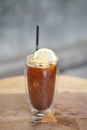 Iced coffee with orange - A plastic glass of espresso shot mixed with orange juice and craft soda on blurred background, Perfect