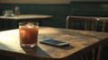 Iced Coffee and Smartphone on Wooden Cafe Table, Morning Light Royalty Free Stock Photo