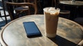 Iced Coffee and Smartphone on Outdoor Cafe Table Royalty Free Stock Photo