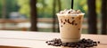 Iced coffee in plastic cup with coffee seeds on cream beige bokeh background, text space