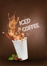 Iced coffee pouring down into a takeaway cup on dark background. Royalty Free Stock Photo