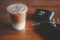 Iced coffee put on the table next to the wallet, car keys and mobile phone in the cafe Royalty Free Stock Photo