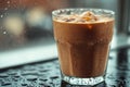 Iced coffee sitting on a rainy window sill refreshing beverage Royalty Free Stock Photo