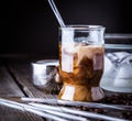 Iced coffee in a small glass with cream poured over. Royalty Free Stock Photo