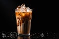 Iced coffee with swirling milk in a glass, coffee beans scattered