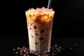 Iced coffee with swirling milk in a glass, coffee beans scattered