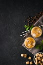 Iced coffee in tall glasses with cream and pieces of sugar, mint Royalty Free Stock Photo