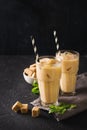 Iced coffee in tall glasses with cream and pieces of sugar, mint Royalty Free Stock Photo