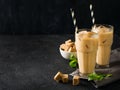 Iced coffee in tall glasses with cream and pieces of sugar, mint Royalty Free Stock Photo