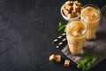 Iced coffee in tall glasses with cream and pieces of sugar, mint Royalty Free Stock Photo