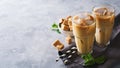 Iced coffee in tall glasses with cream and pieces of sugar, mint Royalty Free Stock Photo