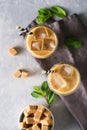 Iced coffee in tall glasses with cream and pieces of sugar, mint Royalty Free Stock Photo