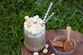 Iced coffee with whipped cream caramel popcorn and cinnamon