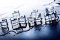 Iced cubes melting on a blue table with reflection. Water. Melting of ice. Royalty Free Stock Photo
