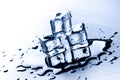 Iced cubes melting on a blue table with reflection. Water. Melting of ice. Royalty Free Stock Photo