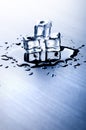 Iced cubes melting on a blue table with reflection. Water. Melting of ice. Royalty Free Stock Photo
