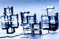 Iced cubes melting on a blue table with reflection. Water. Melting of ice. Royalty Free Stock Photo