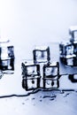 Iced cubes melting on a blue table with reflection. Water. Melting of ice. Royalty Free Stock Photo