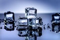 Iced cubes melting on a blue table with reflection. Water. Melting of ice. Royalty Free Stock Photo