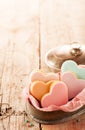 Iced fondant heart shaped biscuits in a tin