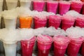 Iced Fruit Smoothies in the flavors of Banana, Grapefruit, Orange, Kiwi, inside Plastic Glasses Royalty Free Stock Photo