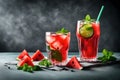 Iced fruit tea or cold watermelon drink in clear glass with mint leaf. Refreshing summer drink. Grey background