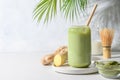 Iced Green matcha latte tea on white table. Space for text. Close up. Horizontal orientation