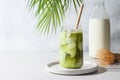 Iced Green matcha tea mixed with ice cube and milk in latte glass on white Royalty Free Stock Photo