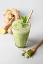 Iced Green matcha tea and pouring milk in latte glass on white table. Space for text. Close up. Horizontal orientation Royalty Free Stock Photo