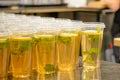 Iced green tea with mint and lemon in plastic transparent glasses with a lid on cafe counter Royalty Free Stock Photo