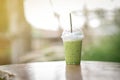 Iced green tea placed on the table background blurred