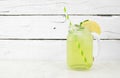 Iced herbal green tea in a mason jar glass against white wood Royalty Free Stock Photo