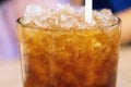 Iced honey lemon tea in glass background close up