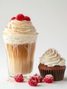 Iced latte decorated with whipped cream and raspberries and chocolate cupcake.