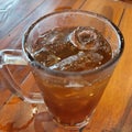 Iced lemon tea with ice cubes in a large glass