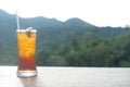 Iced lemon tea in long glass on the green nature background Royalty Free Stock Photo