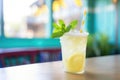 iced lemonade with mint leaves and a striped straw