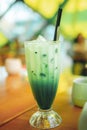 Iced matcha green tea latte with Milk in tall glass. Royalty Free Stock Photo