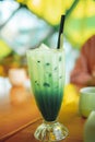 Iced matcha green tea latte with Milk in tall glass. Royalty Free Stock Photo