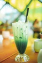 Iced matcha green tea latte with Milk in tall glass. Royalty Free Stock Photo