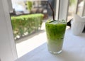 Iced matcha green tea with milk with straw in glass Royalty Free Stock Photo